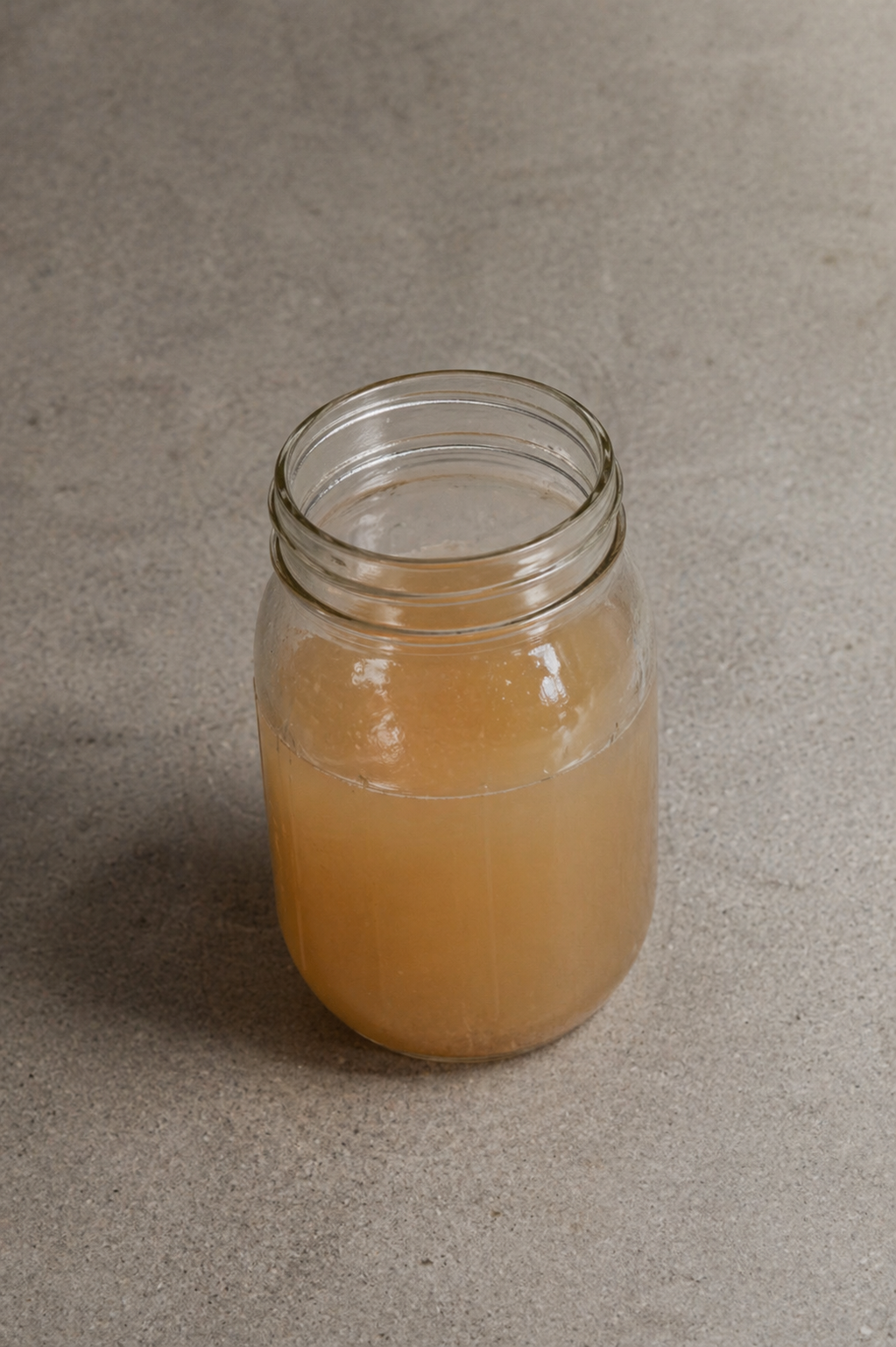 Homemade apple pectin in a glass jar made from green apples
