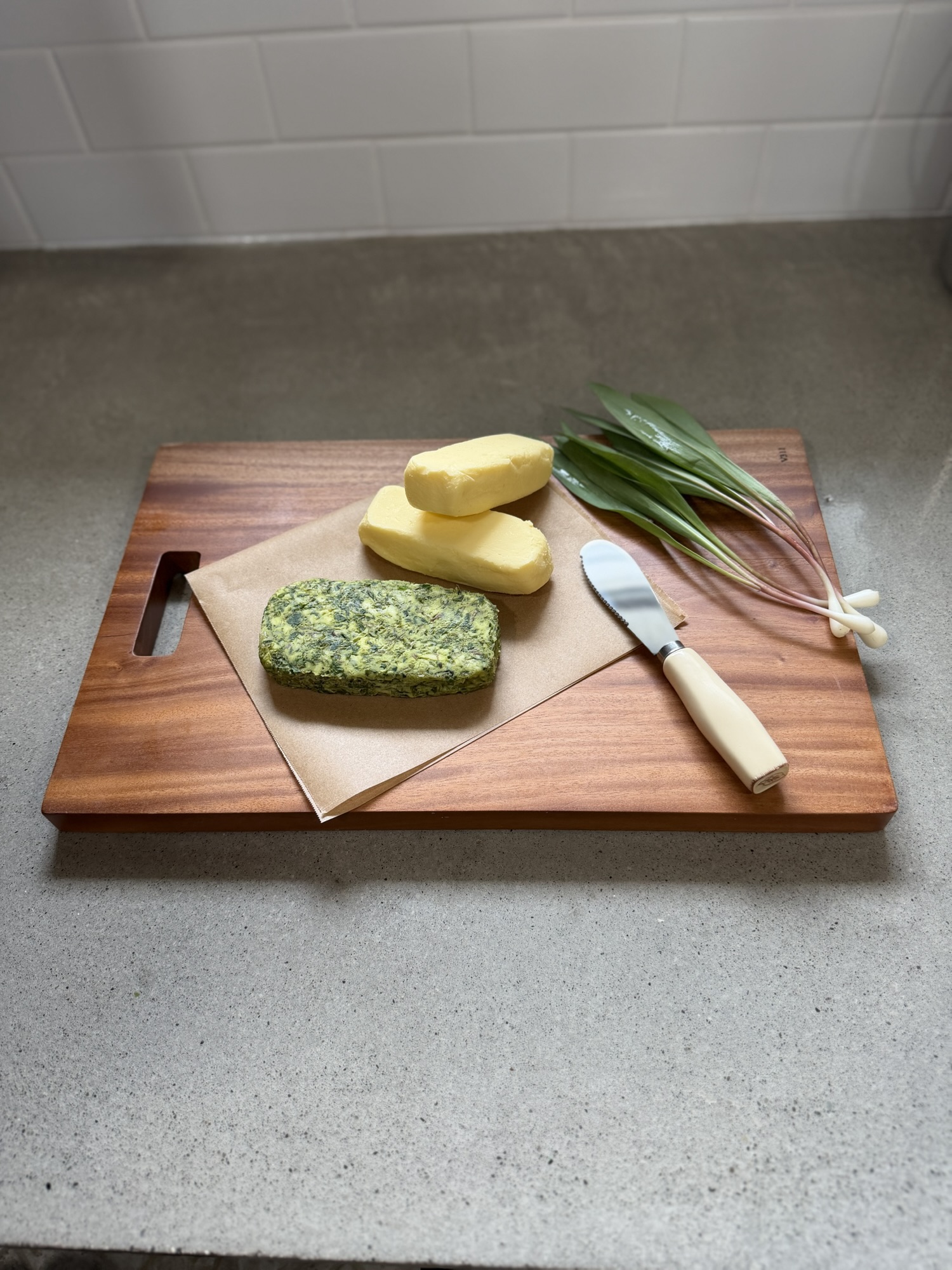 Homemade leek butter in a bowl with visible sautéed leeks, creamy texture, and fresh herbs